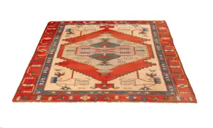 A rectangular Turkish rug with a cream-colored field, red geometric patterns, and a blue and red border.