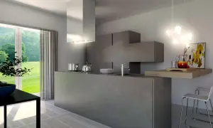 Cucina moderna con isola centrale in **resina dietro cucina**, pensili a scomparsa e vista sul verde.