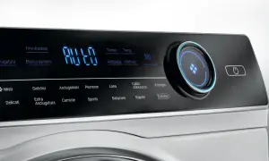Pannello comandi asciugatrice Hoover con display digitale e simboli per programmi come Cotone, Lana, Babycare. Istruzioni chiare per ogni ciclo.
