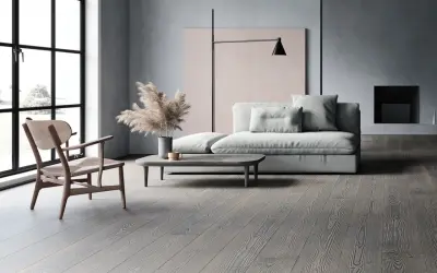 Soggiorno moderno con divano grigio chiaro, un tavolino e un pavimento in legno grigio.