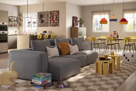 Un divano grigio moderno, con cuscini colorati, è il protagonista. Accanto, giochi da tavolo e una scultura a forma di coniglio. Ottime idee su cosa mettere dietro al divano per un tocco di stile.
