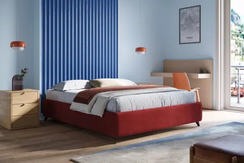 Un letto sommier rosso, con comodino in legno e parete blu a coste. Un'idea di design moderno per la camera.