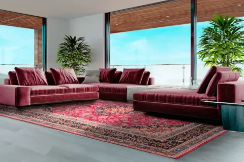 Soggiorno moderno con divano bordeaux e un tappeto persiano dai colori vivaci, che mostra diversi tipi di tappeti persiani.
