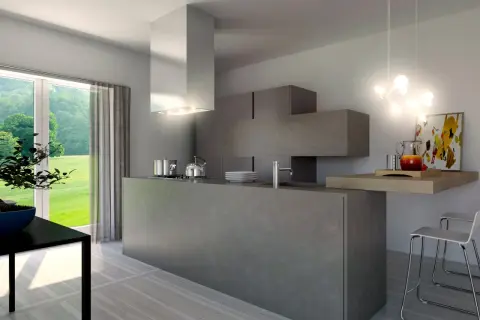 Cucina moderna con isola centrale in **resina dietro cucina**, pensili a scomparsa e vista sul verde.