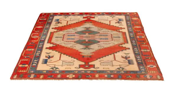 A rectangular Turkish rug with a cream-colored field, red geometric patterns, and a blue and red border.