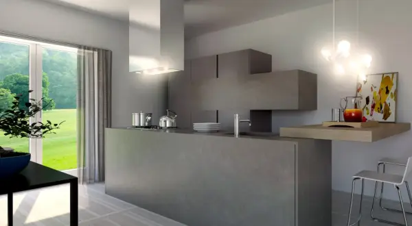 Cucina moderna con isola centrale in **resina dietro cucina**, pensili a scomparsa e vista sul verde.
